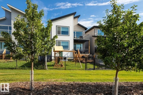 View of back of house with upper level balcony, 2 tiered deck, fenced yard with dog run. - 5 Starling, Fort Saskatchewan, AB 
