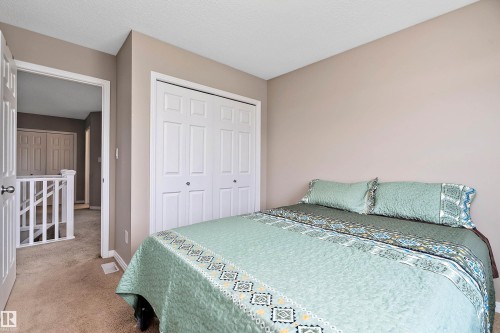 Carpeted bedroom featuring a closet and a textured ceiling - 33 Sutherland Street, Leduc, AB - Indoor Photo Showing Bedroom