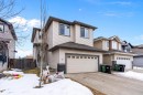 View of front of property with concrete driveway, an attached garage, and stone siding - 33 Sutherland Street, Leduc, AB  - Outdoor 
