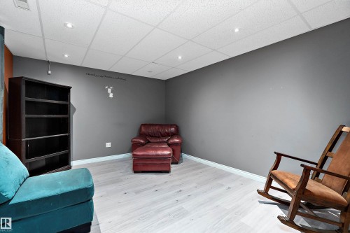 Living area with a drop ceiling, light wood-style floors, and recessed lighting - 33 Sutherland Street, Leduc, AB - Indoor