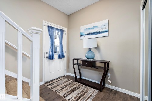 Foyer entrance featuring stairs and dark wood finished floors - 33 Sutherland Street, Leduc, AB - Indoor Photo Showing Other Room