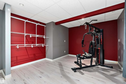 Workout room featuring a paneled ceiling and light wood-type flooring - 33 Sutherland Street, Leduc, AB - Indoor Photo Showing Gym Room