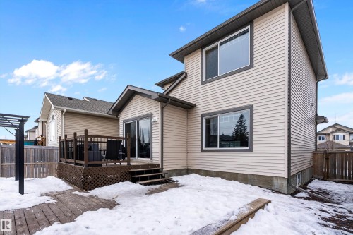 Snow covered property with a deck - 33 Sutherland Street, Leduc, AB - Outdoor With Deck Patio Veranda
