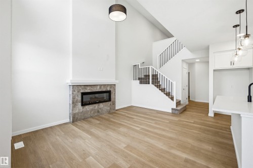 5107 69 Street, Beaumont, AB - Indoor Photo Showing Other Room With Fireplace