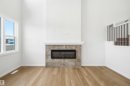 5107 69 Street, Beaumont, AB - Indoor Photo Showing Living Room With Fireplace