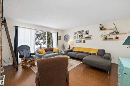 Living room featuring dark wood-style flooring and baseboards - 12 Beacon Crescent, St. Albert, AB - Indoor Photo Showing Living Room