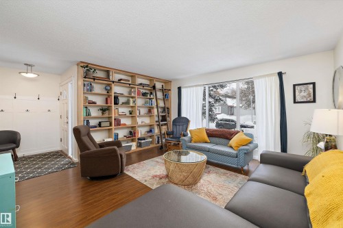 Living room featuring wood finished floors and a textured ceiling - 12 Beacon Crescent, St. Albert, AB - Indoor Photo Showing Living Room