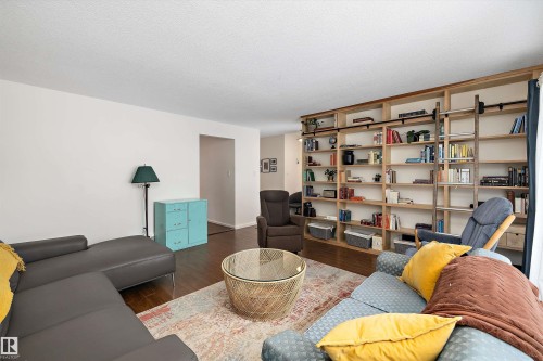 Living area with dark wood-type flooring and a textured ceiling - 12 Beacon Crescent, St. Albert, AB - Indoor Photo Showing Living Room