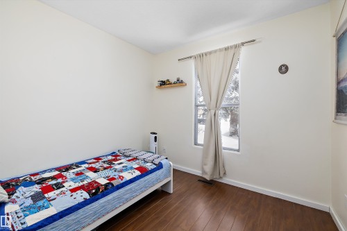 Bedroom featuring baseboards and dark wood-style floors - 12 Beacon Crescent, St. Albert, AB - Indoor Photo Showing Bedroom