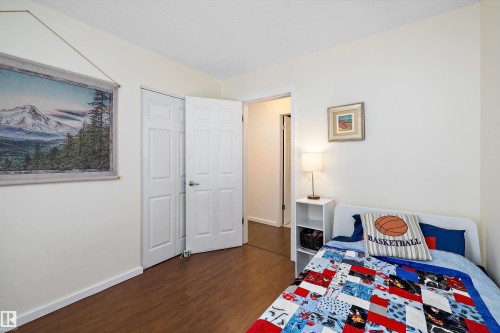 Bedroom with dark wood-style floors and baseboards - 12 Beacon Crescent, St. Albert, AB - Indoor Photo Showing Other Room