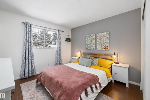 Bedroom with dark wood finished floors and baseboards - 12 Beacon Crescent, St. Albert, AB - Indoor Photo Showing Bedroom