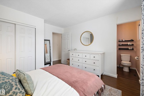 Bedroom featuring a closet and dark wood-style floors - 12 Beacon Crescent, St. Albert, AB - Indoor Photo Showing Bedroom