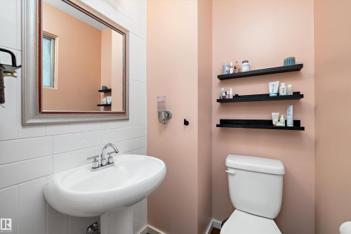 Half bath featuring tile walls and backsplash - 12 Beacon Crescent, St. Albert, AB - Indoor Photo Showing Bathroom