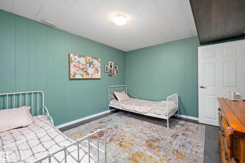 Bedroom featuring wooden walls - 12 Beacon Crescent, St. Albert, AB - Indoor Photo Showing Bedroom