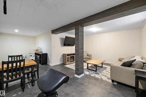 Living area featuring crown molding and recessed lighting - 12 Beacon Crescent, St. Albert, AB - Indoor With Fireplace