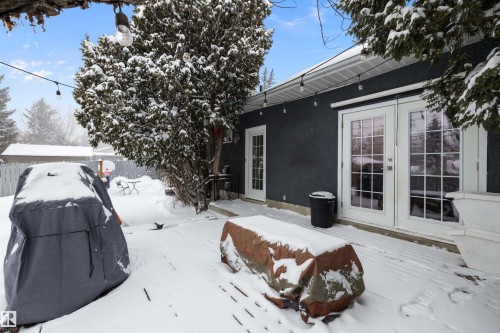 Snow covered house featuring french doors and stucco siding - 12 Beacon Crescent, St. Albert, AB - Outdoor