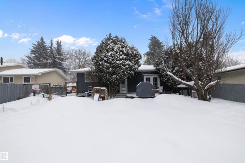 Snow covered back of property featuring french doors and a gate - 12 Beacon Crescent, St. Albert, AB - Outdoor