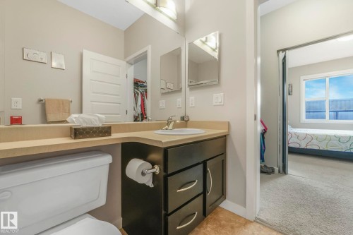 Ensuite bathroom featuring light carpet and vanity - 122 304 Ambleside Link Link, Edmonton, AB - Indoor Photo Showing Bathroom