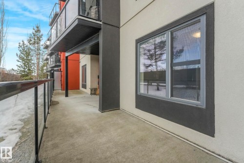 View of home's exterior featuring a balcony and stucco siding - 122 304 Ambleside Link Link, Edmonton, AB - Outdoor With Exterior