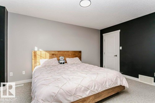 Bedroom featuring light carpet and a textured ceiling - 1381 Rutherford Road, Edmonton, AB - Indoor Photo Showing Bedroom
