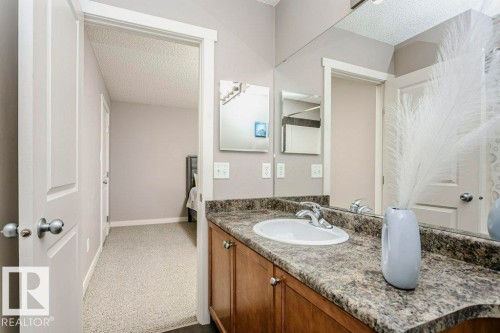 Ensuite bathroom with a textured ceiling, vanity, and carpet flooring - 1381 Rutherford Road, Edmonton, AB - Indoor Photo Showing Bathroom