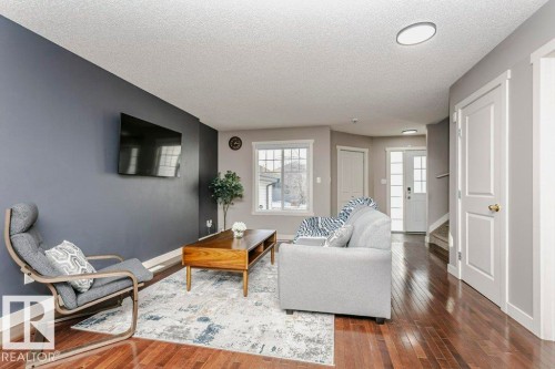 Living room with hardwood / wood-style flooring and a textured ceiling - 1381 Rutherford Road, Edmonton, AB - Indoor Photo Showing Living Room