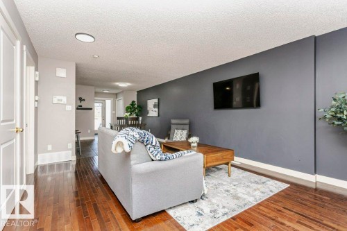 Living area with dark wood finished floors and a textured ceiling - 1381 Rutherford Road, Edmonton, AB - Indoor Photo Showing Living Room