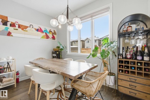 Dining area featuring dark wood-style flooring and suspended lighting - 9942 222A St Nw, Edmonton, AB - Indoor Photo Showing Dining Room