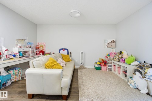 Playroom featuring wood finished floors and baseboards - 9942 222A St Nw, Edmonton, AB - Indoor