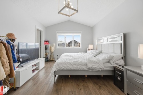 Bedroom featuring suspended lighting and wood finished floors - 9942 222A St Nw, Edmonton, AB - Indoor Photo Showing Bedroom