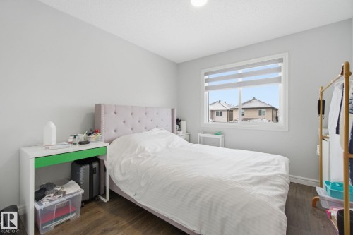 Bedroom with dark wood finished floors and baseboards - 9942 222A St Nw, Edmonton, AB - Indoor Photo Showing Bedroom