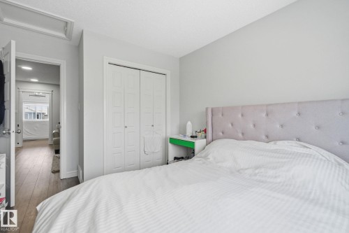 Bedroom featuring dark wood-style flooring and a closet - 9942 222A St Nw, Edmonton, AB - Indoor Photo Showing Bedroom
