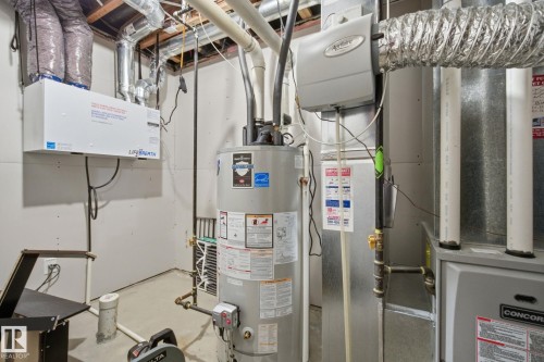 Utilities with gas water heater and heating unit - 9942 222A St Nw, Edmonton, AB - Indoor Photo Showing Basement
