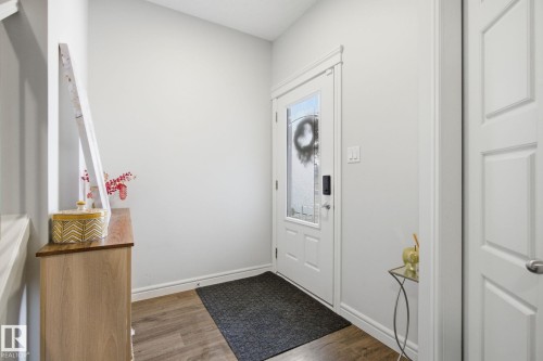 Entrance foyer featuring baseboards and wood finished floors - 9942 222A St Nw, Edmonton, AB - Indoor Photo Showing Other Room