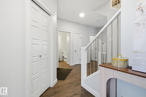Corridor featuring dark wood-type flooring and stairs - 9942 222A St Nw, Edmonton, AB - Indoor Photo Showing Other Room
