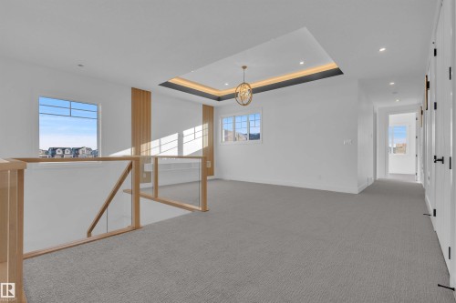 Empty room with a raised ceiling, light colored carpet, and recessed lighting - 463 Crystal Creek Link, Leduc, AB - Indoor Photo Showing Other Room
