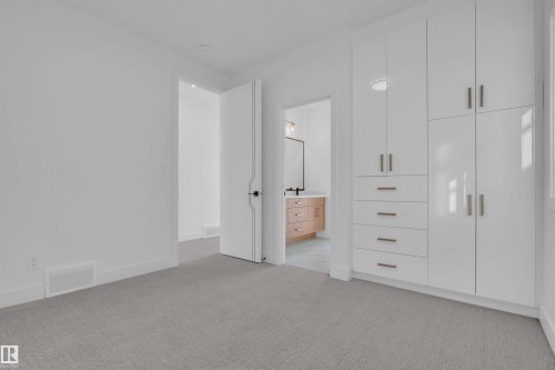 Unfurnished bedroom with light carpet and connected bathroom - 463 Crystal Creek Link, Leduc, AB - Indoor Photo Showing Other Room