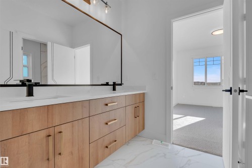 Full bathroom with double vanity, light carpet, and light marble finish floors - 463 Crystal Creek Link, Leduc, AB - Indoor Photo Showing Other Room