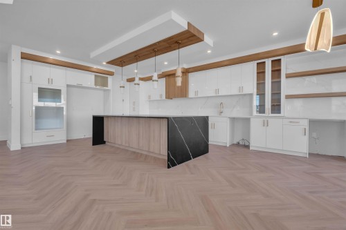 Kitchen with dual tone cabinets, modern cabinets, parquet floors, and pendant lighting - 463 Crystal Creek Link, Leduc, AB - Indoor Photo Showing Kitchen