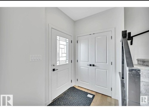 Entrance foyer featuring light wood-type flooring and stairway - 426 Crystal Creek Link, Leduc, AB - Indoor Photo Showing Other Room