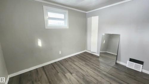 Spare room with ornamental molding and wood finished floors - 12139 81 Street, Edmonton, AB - Indoor Photo Showing Other Room