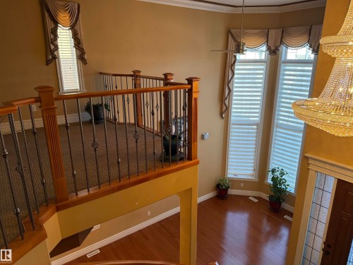 Stairway with crown molding and wood finished floors - 816 Wildwood Crescent Nw, Edmonton, AB - Indoor Photo Showing Other Room