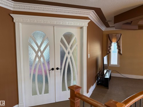 Entryway with french doors, carpet, ornamental molding, and a textured ceiling - 816 Wildwood Crescent Nw, Edmonton, AB - Indoor Photo Showing Other Room