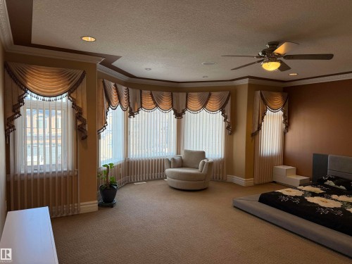 Bedroom with crown molding, carpet flooring, a textured ceiling, and ceiling fan - 816 Wildwood Crescent Nw, Edmonton, AB - Indoor Photo Showing Other Room