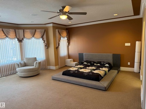 Bedroom featuring ceiling fan, light carpet, a textured ceiling, ornamental molding, and recessed lighting - 816 Wildwood Crescent Nw, Edmonton, AB - Indoor Photo Showing Bedroom