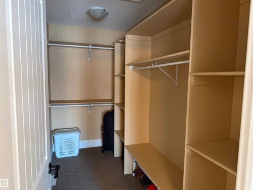 Walk in closet with dark carpet - 816 Wildwood Crescent Nw, Edmonton, AB - Indoor