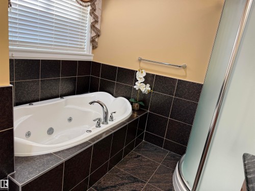 Bathroom with a whirlpool tub, a shower stall, and tile walls - 816 Wildwood Crescent Nw, Edmonton, AB - Indoor Photo Showing Bathroom