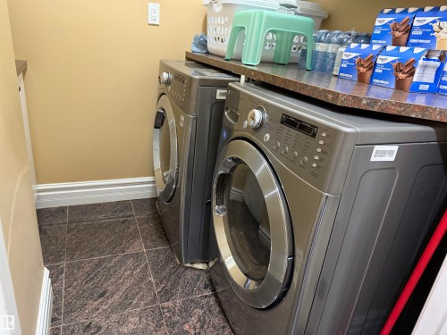Laundry room with granite tiled floors and washer and dryer - 816 Wildwood Crescent Nw, Edmonton, AB - Indoor Photo Showing Laundry Room