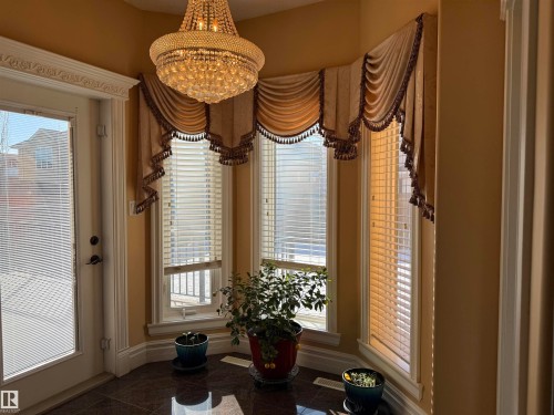 Detailed view of baseboards and a chandelier - 816 Wildwood Crescent Nw, Edmonton, AB - Indoor Photo Showing Other Room