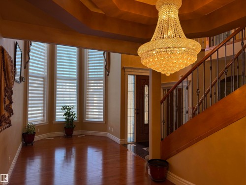 Entrance foyer with hanging lights and hardwood / wood-style floors - 816 Wildwood Crescent Nw, Edmonton, AB - Indoor Photo Showing Other Room